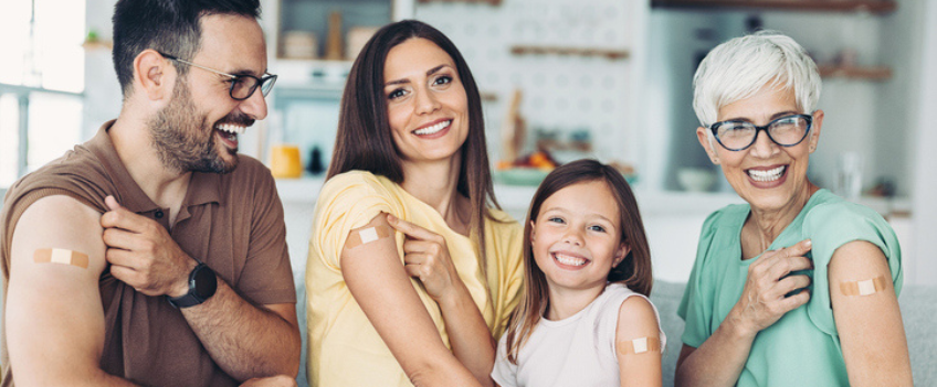 Family showing they've been vaccinated for COVID-19